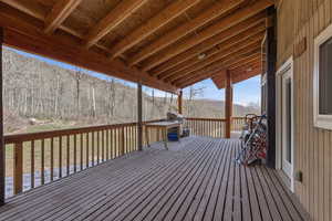 Deck with a grill and a mountain view