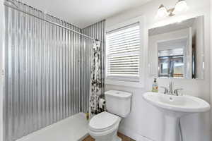 Full bathroom featuring a shower stall