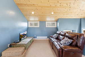 Living area with a vaulted wood ceiling, carpet, and recessed lighting