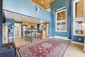 Dining space with light wood finished floors, recessed lighting, and a high wooden ceiling