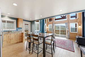 Dining room featuring a wood stove, recessed lighting, and light wood finished floors