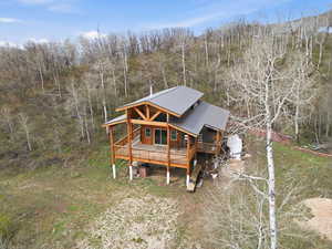 View of front of home featuring a deck and a metal roof