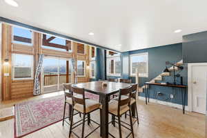 Dining area with a mountain view, light wood-style floors, and recessed lighting