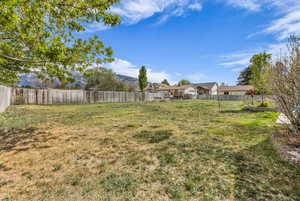 Fenced backyard with a mountain view