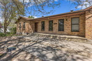 Back of property featuring brick siding