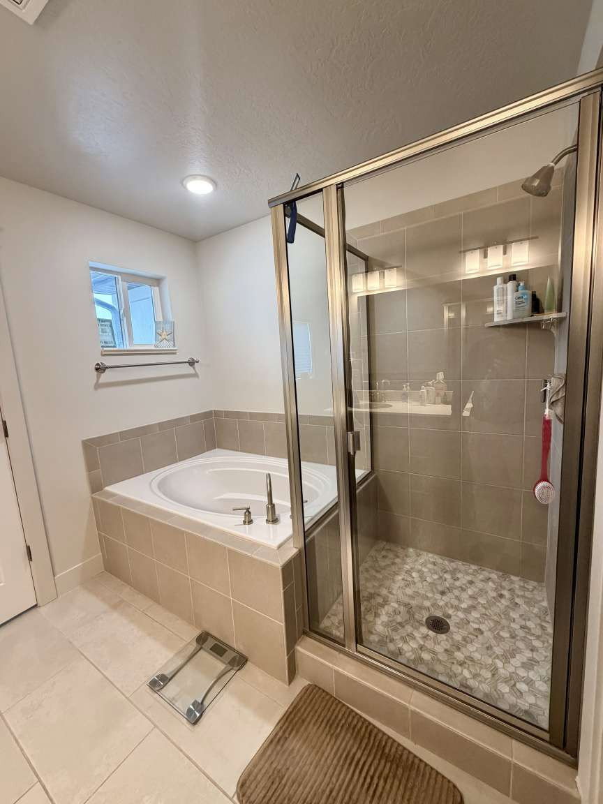 Shower enclosure with bronze-finish frame and pebble-style floor