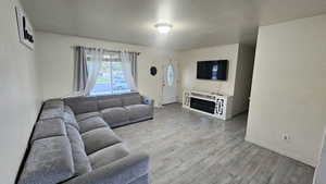 Living room with light wood-style floors and baseboards