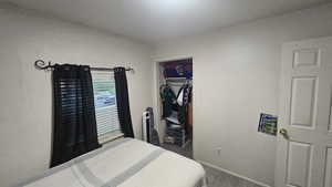 Bedroom with wood finished floors and a closet