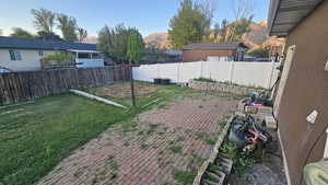 Fenced backyard featuring a mountain view