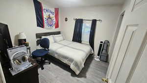 Bedroom featuring light wood-type flooring and baseboards