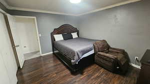 Bedroom featuring crown molding and wood finished floors