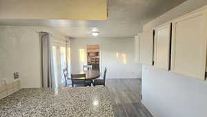Dining area with light wood-type flooring and baseboards