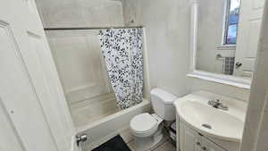 Bathroom with vanity and shower / tub combo with curtain