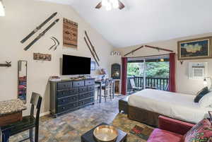 Bedroom featuring access to exterior, lofted ceiling, and ceiling fan