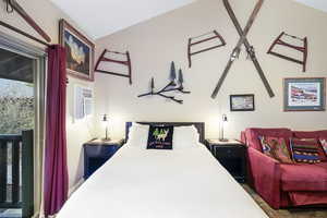 Bedroom featuring a wall mounted air conditioner and access to outside