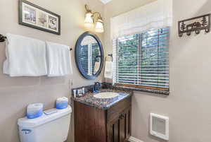 Half bathroom with vanity and heating unit