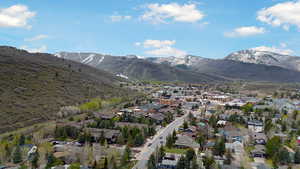 Aerial perspective of suburban area with a mountainous background and property boundaries highlighted