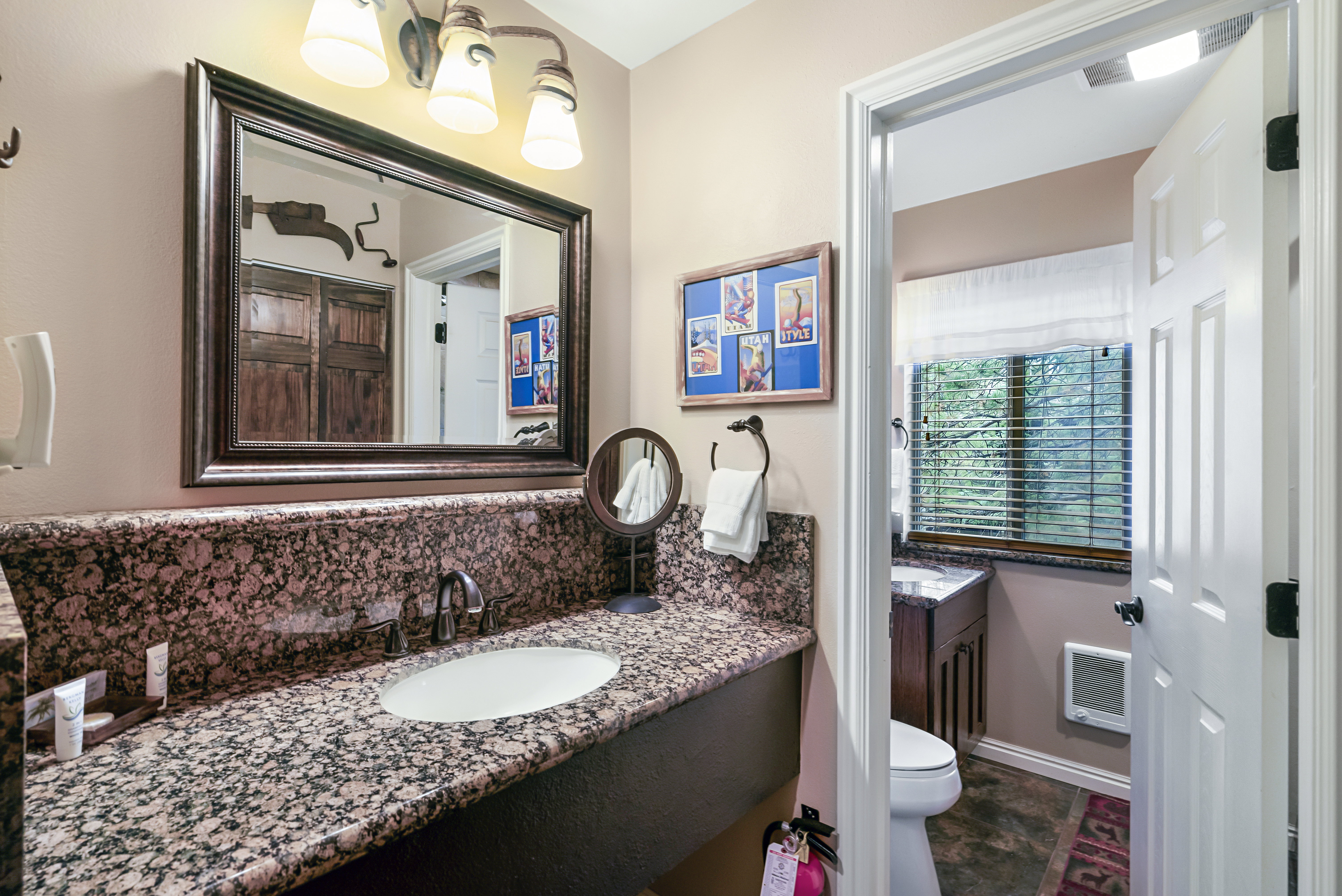 Bathroom with vanity, tasteful backsplash, dark stone finish floors, and heating unit
