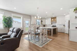 Dining area featuring light wood-type flooring and a chandelier