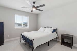 Bedroom with light colored carpet and a ceiling fan