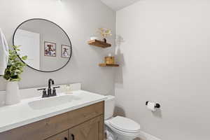 Half bath featuring vanity and toilet