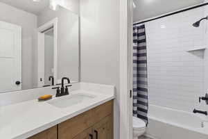 Full bath featuring vanity and shower / bath combo