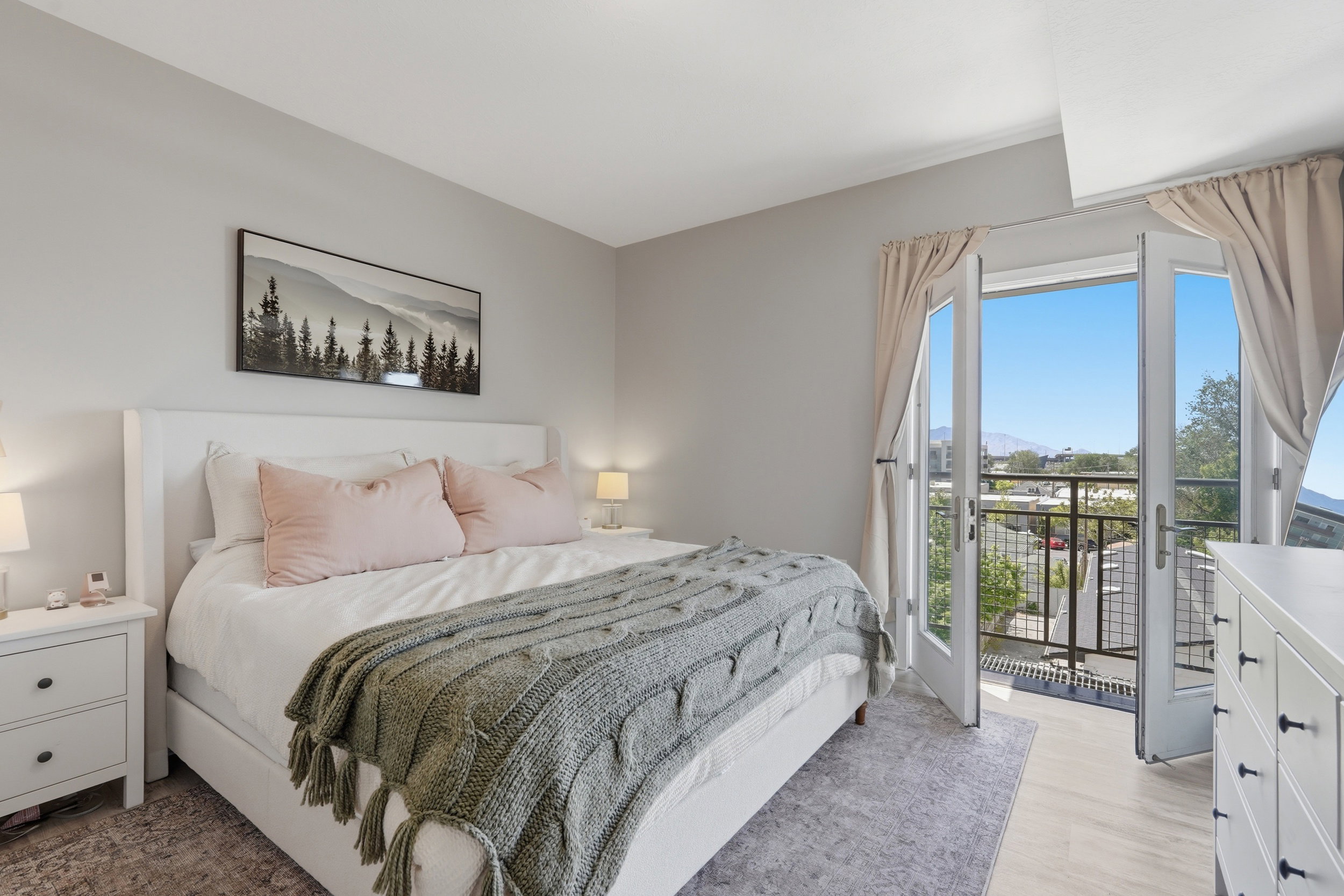 Bedroom with access to outside and light wood-style floors