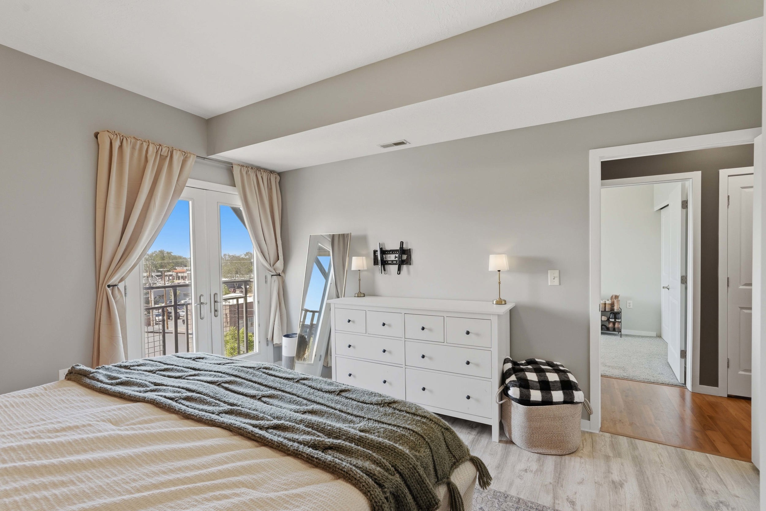 Bedroom featuring access to outside, light wood-style flooring, and french doors