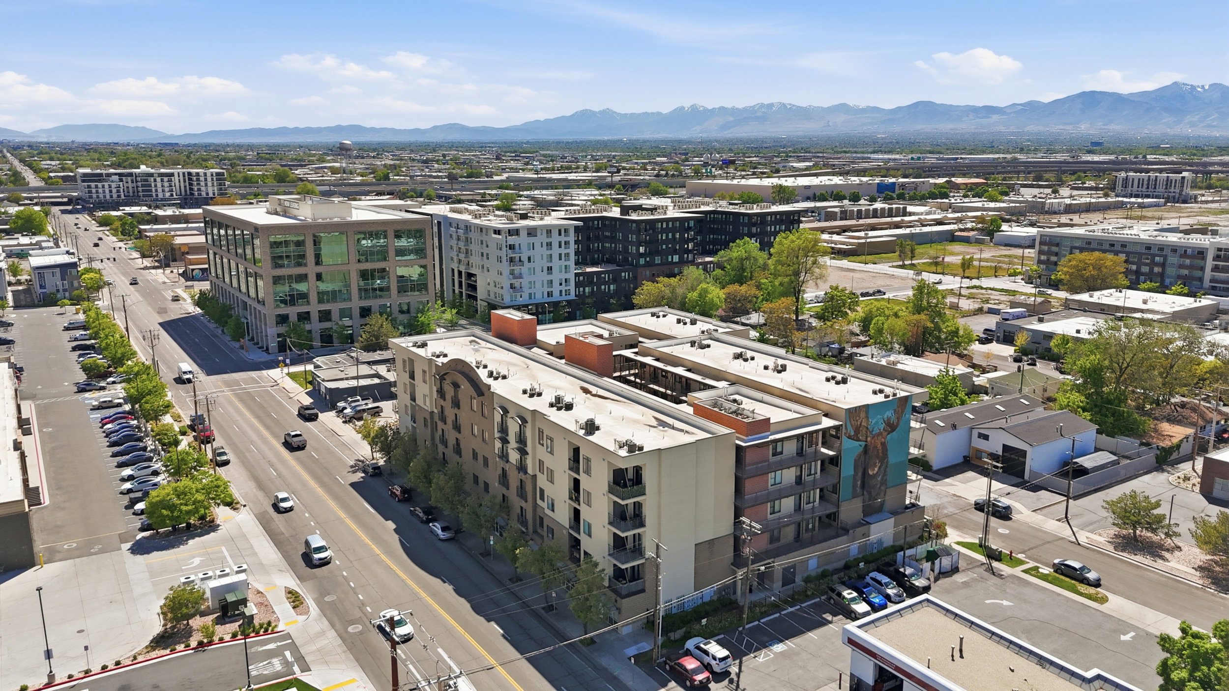 View of urban area with mountains and apartment complex / building