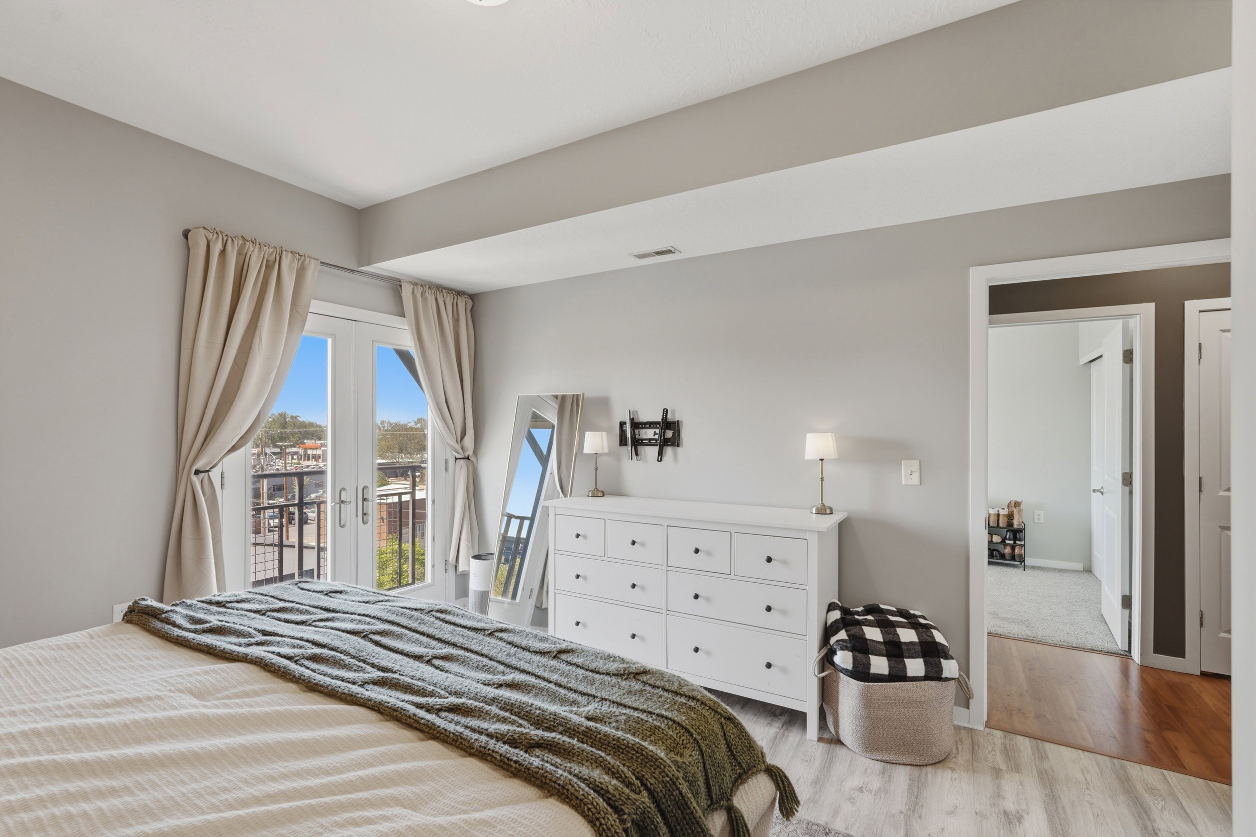 Bedroom featuring french doors, light wood-style floors, and access to exterior