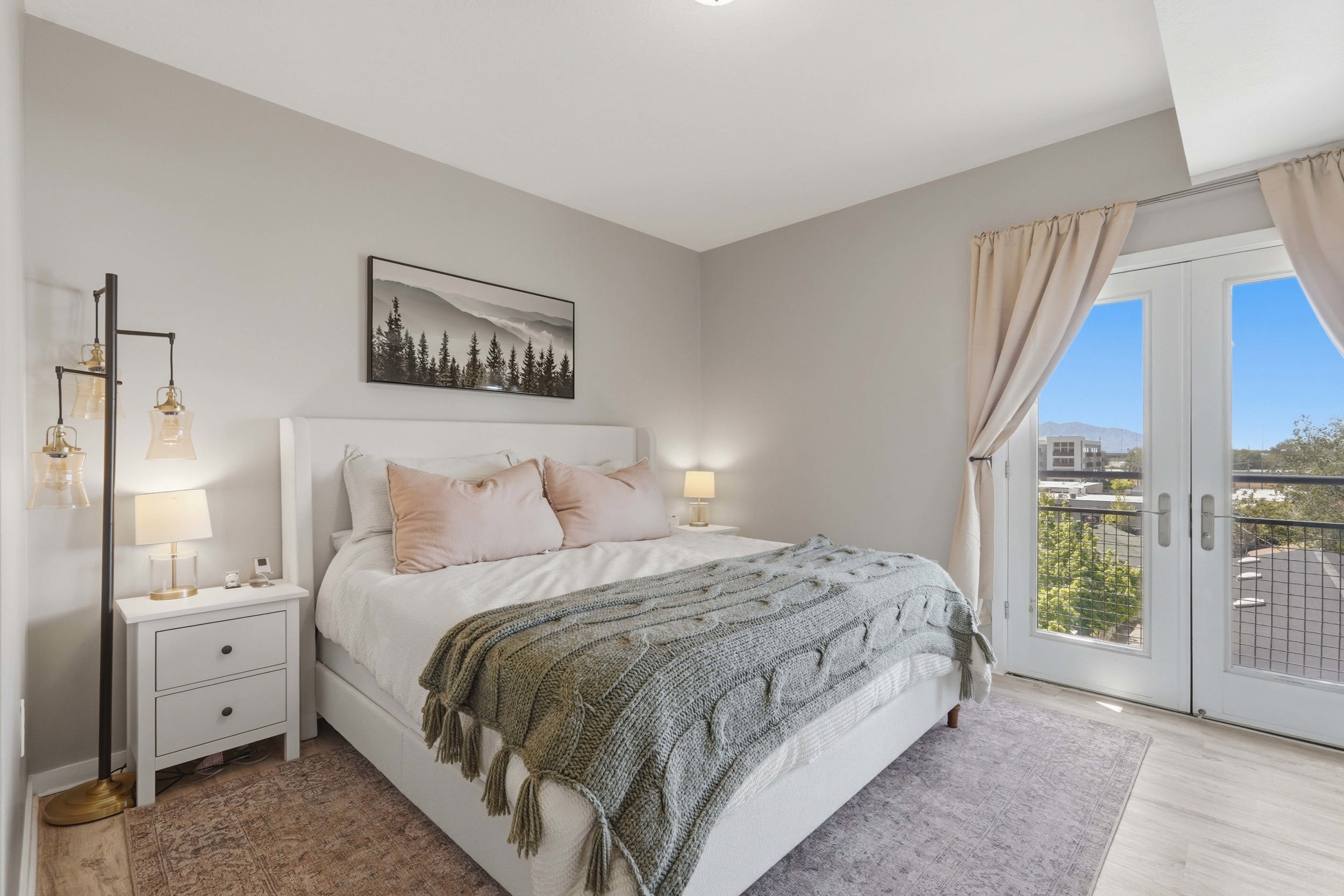 Bedroom featuring french doors, access to exterior, and light wood finished floors