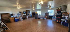 Living area with wood finished floors and a textured ceiling