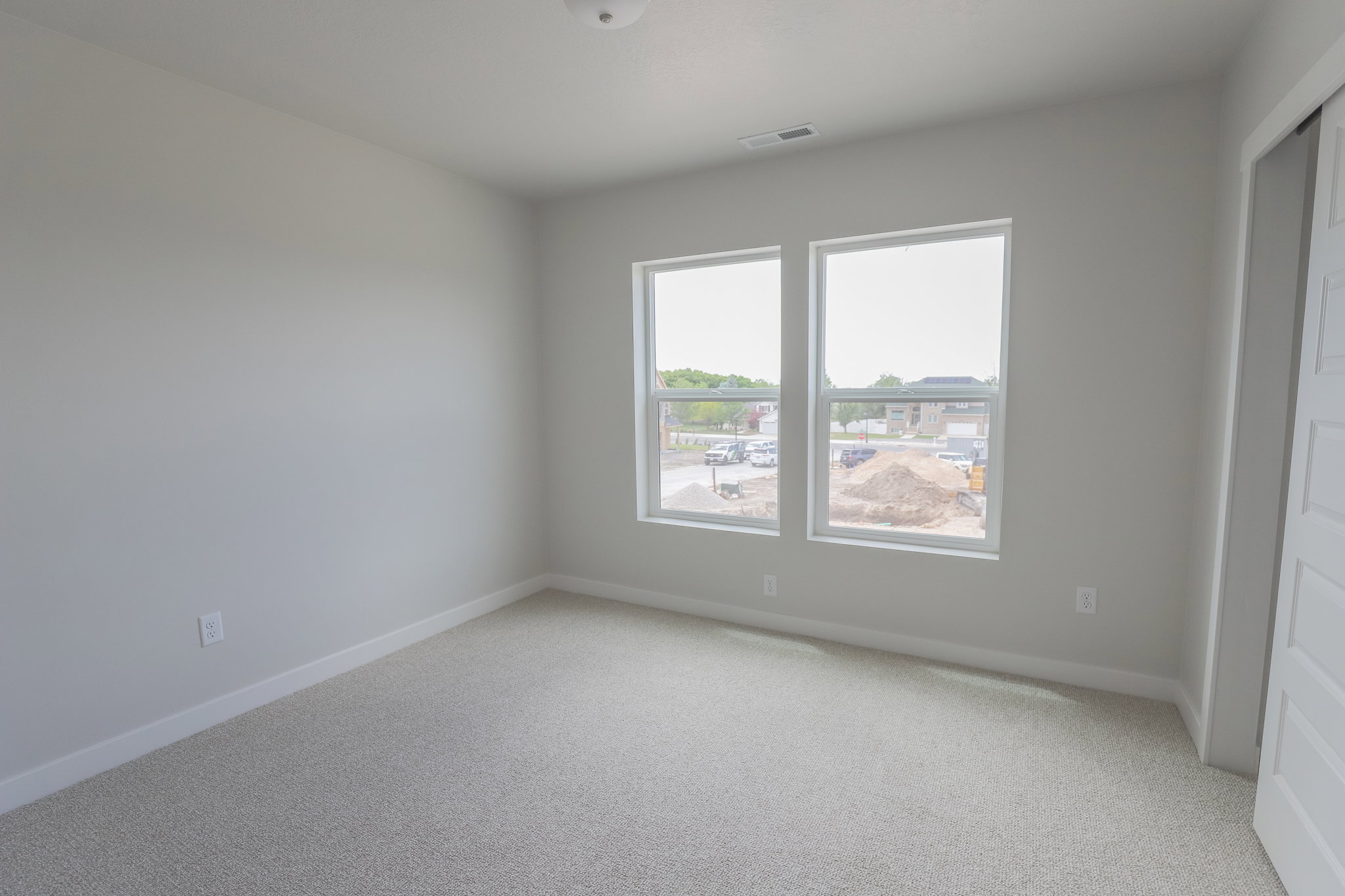 Bright room with light gray carpeting and white baseboards