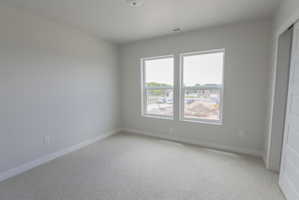 Bright room with light gray carpeting and white baseboards