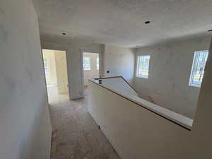 Hall with healthy amount of natural light and an upstairs landing