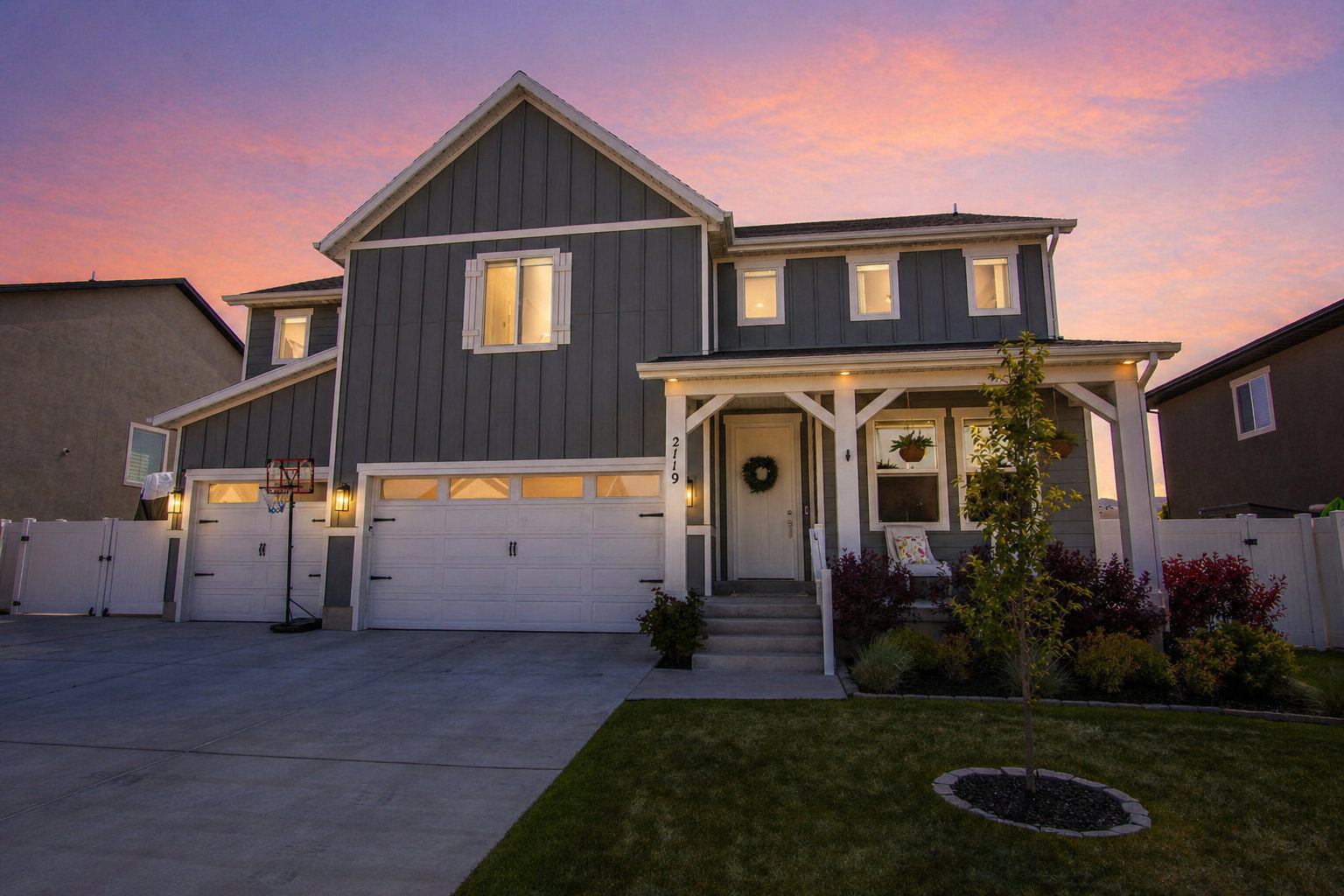 Modern farmhouse style home with a gate, board and batten siding, concrete driveway, a porch, and a garage