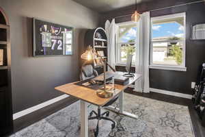 Office space featuring dark wood finished floors and baseboards