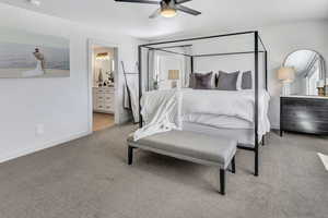Bedroom with ceiling fan, light carpet, connected bathroom, and a textured ceiling