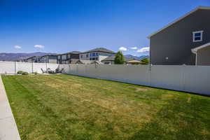 Fenced backyard with a mountain view