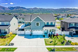 Traditional home featuring a gate, board and batten siding, a residential view, and a mountain view