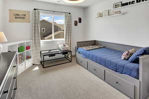 Bedroom featuring light colored carpet