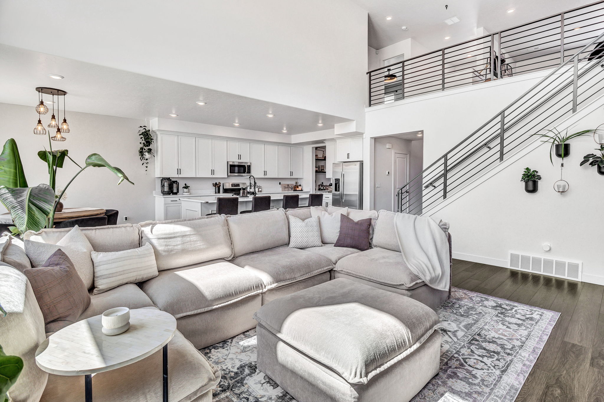 Living area featuring dark wood finished floors, recessed lighting, and a high ceiling