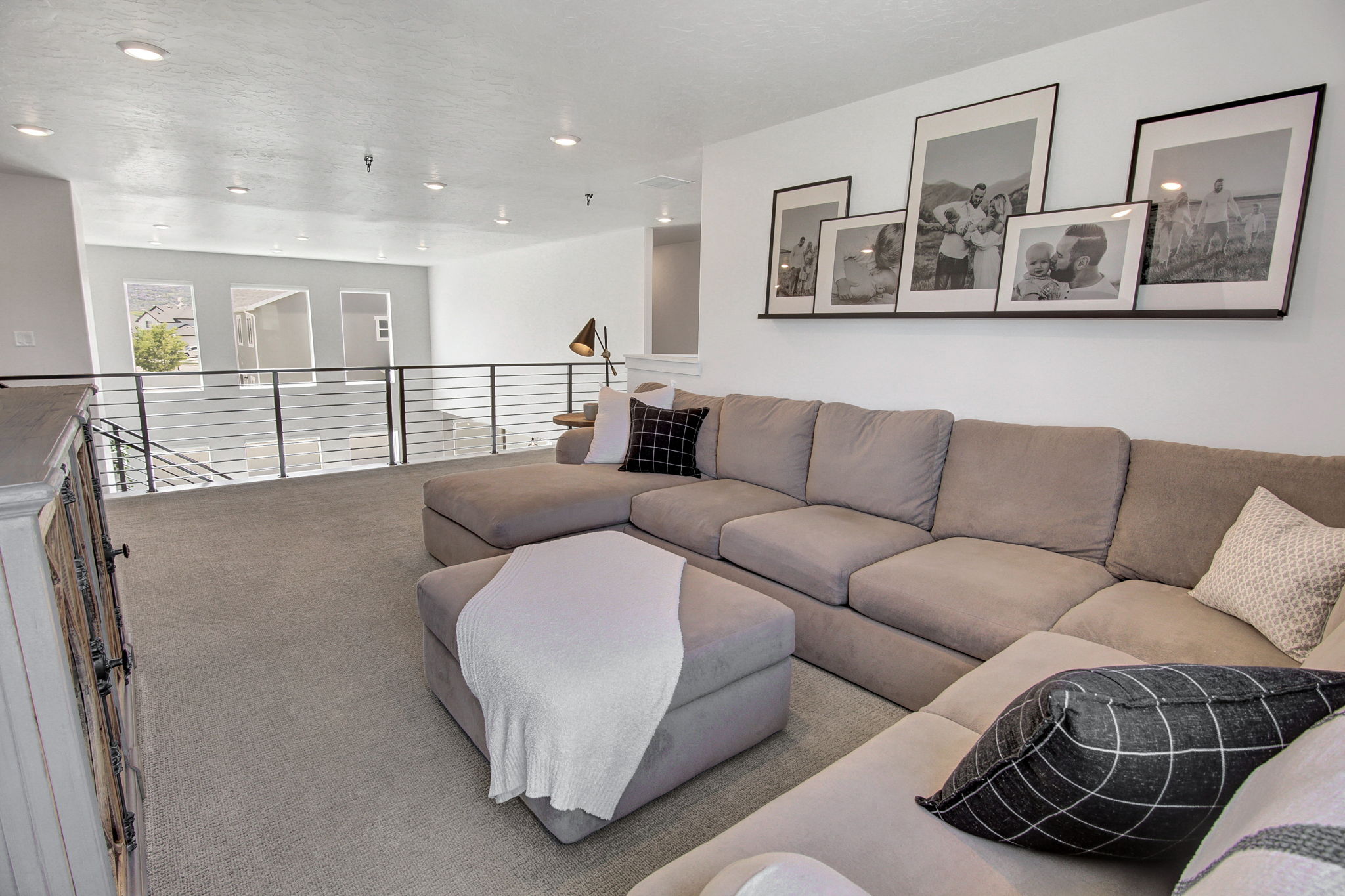 Carpeted living area with recessed lighting
