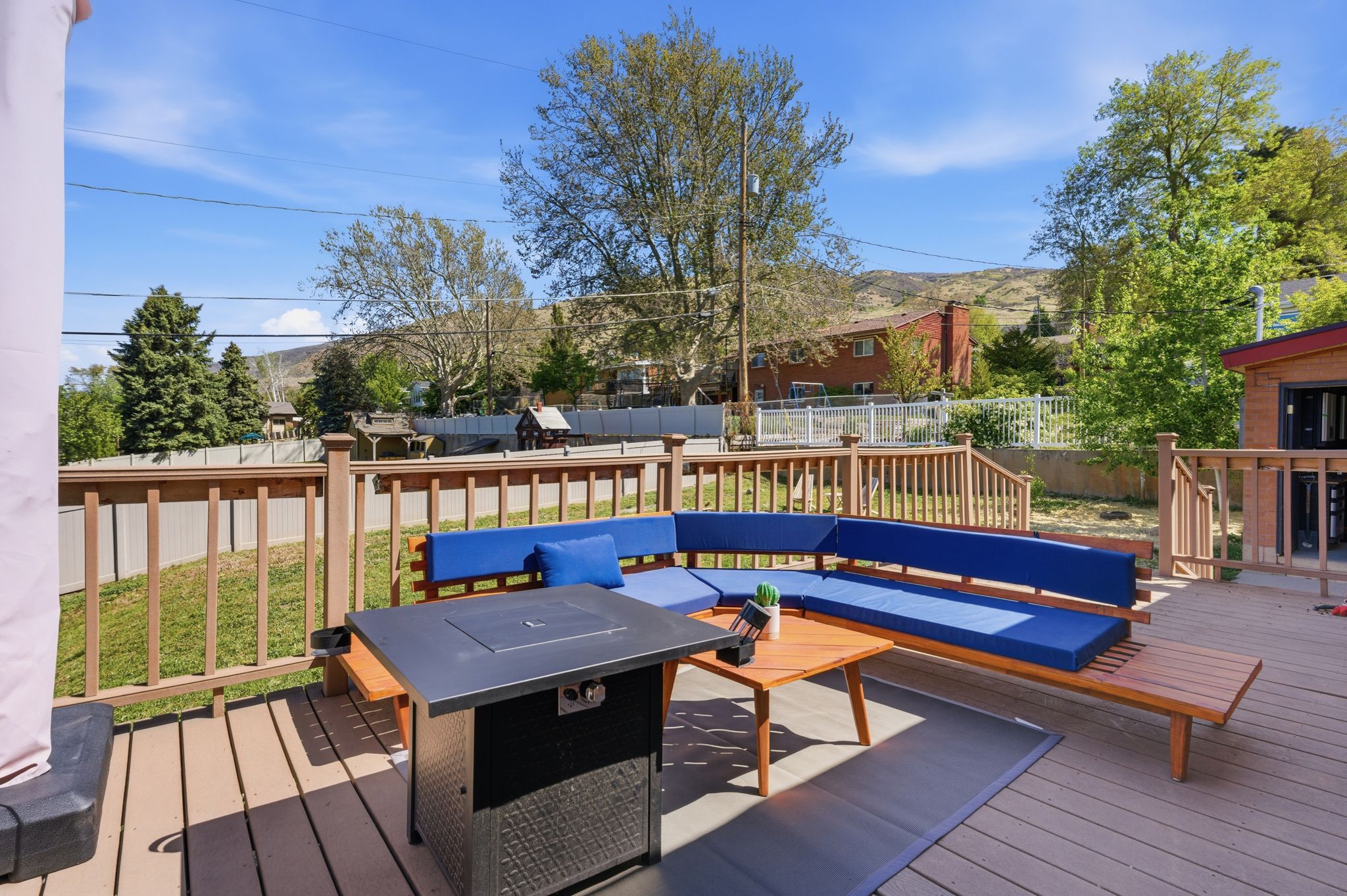 Deck with a fenced backyard, an outdoor hangout area, and a mountain view