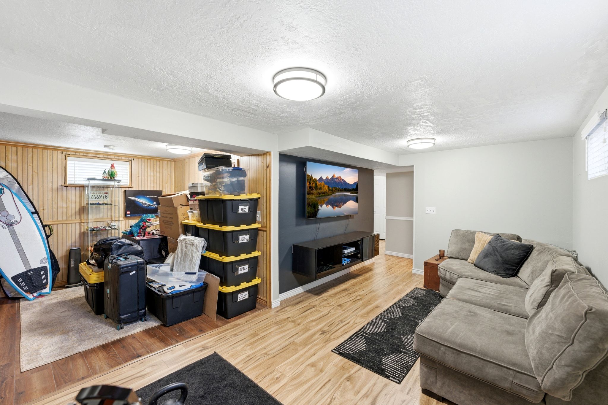 Living area with light wood-style flooring and a textured ceiling