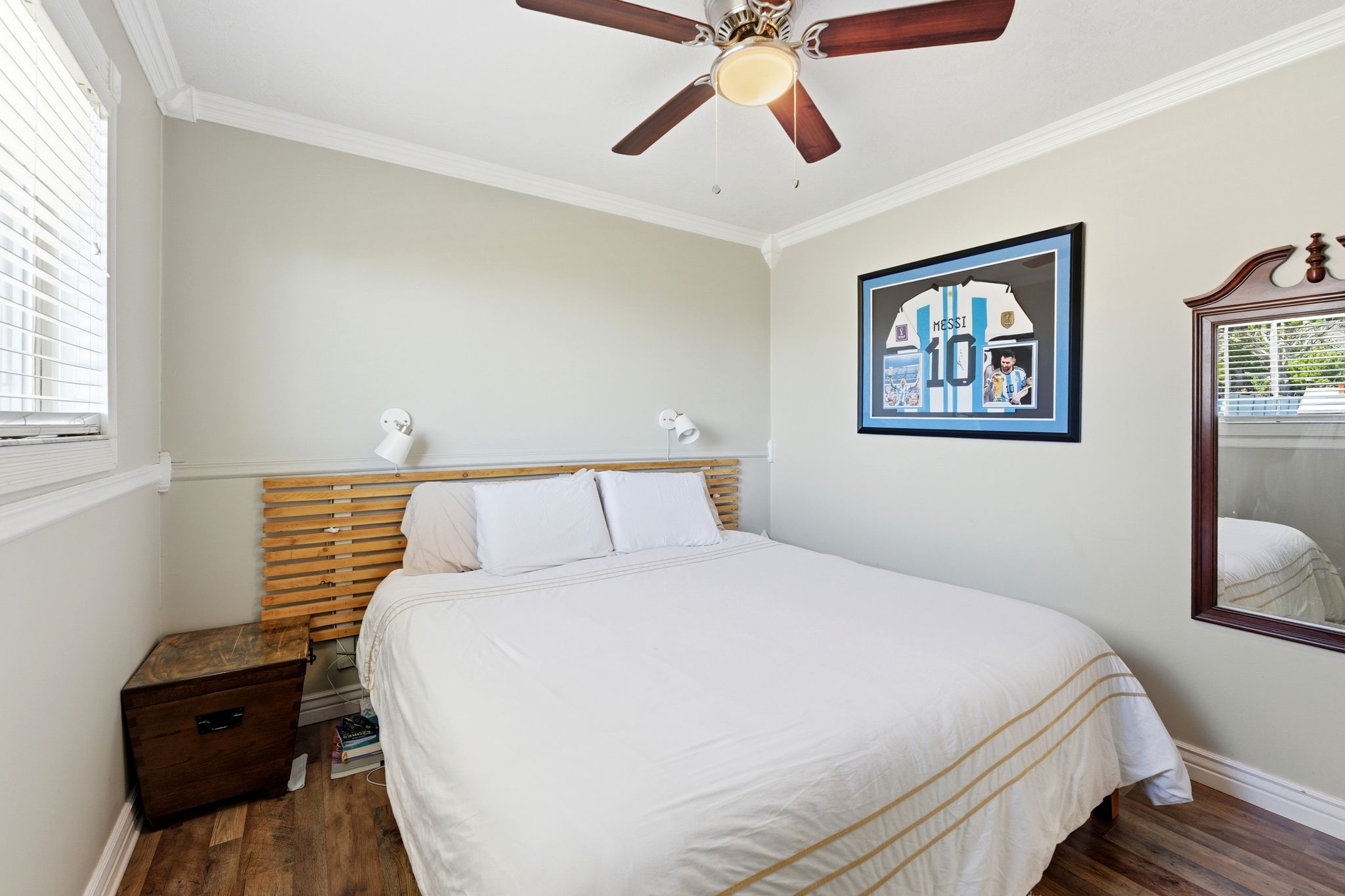 Bedroom with ornamental molding, a ceiling fan, and dark wood finished floors