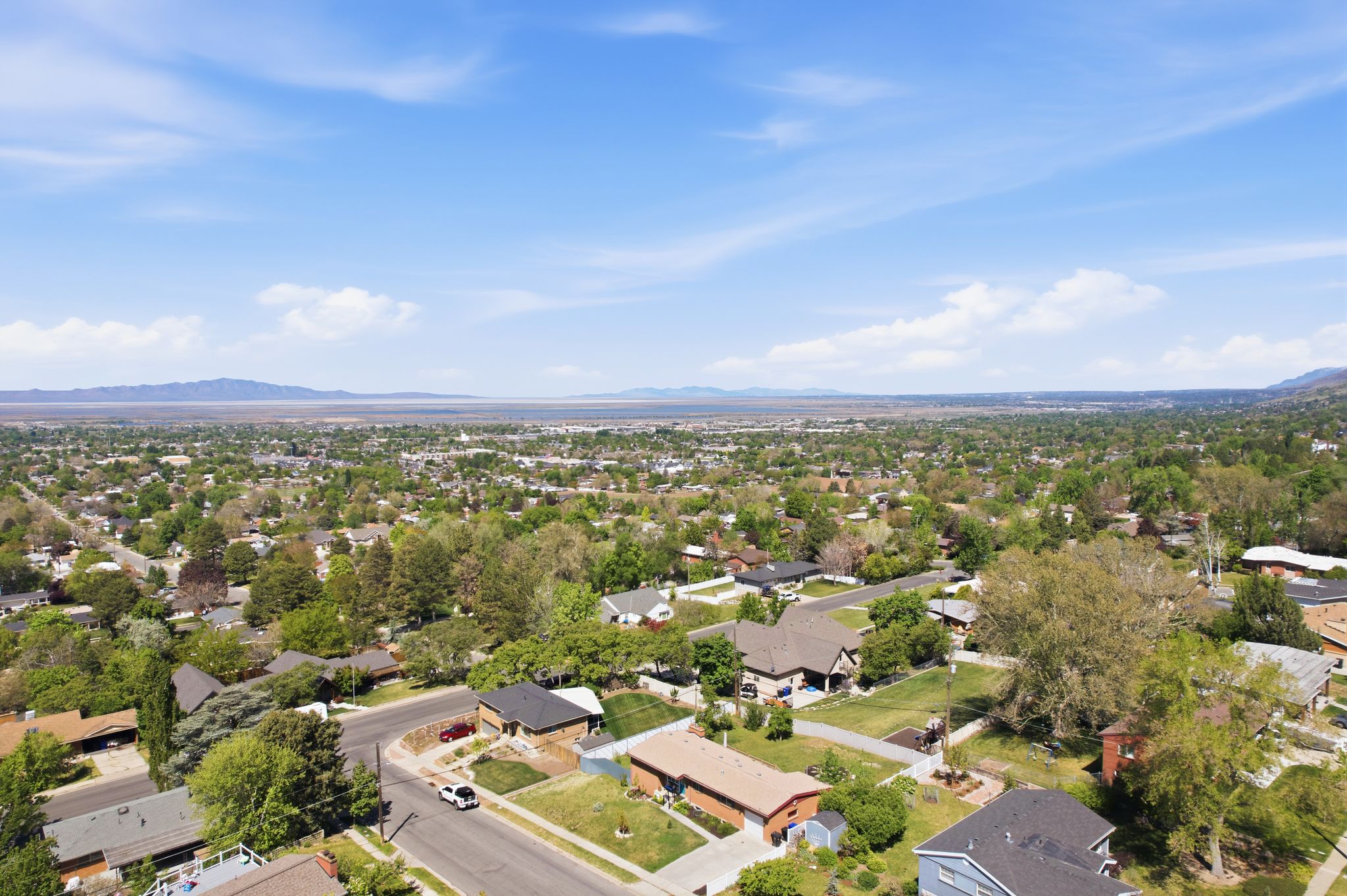 Aerial perspective of suburban area featuring a mountain backdrop