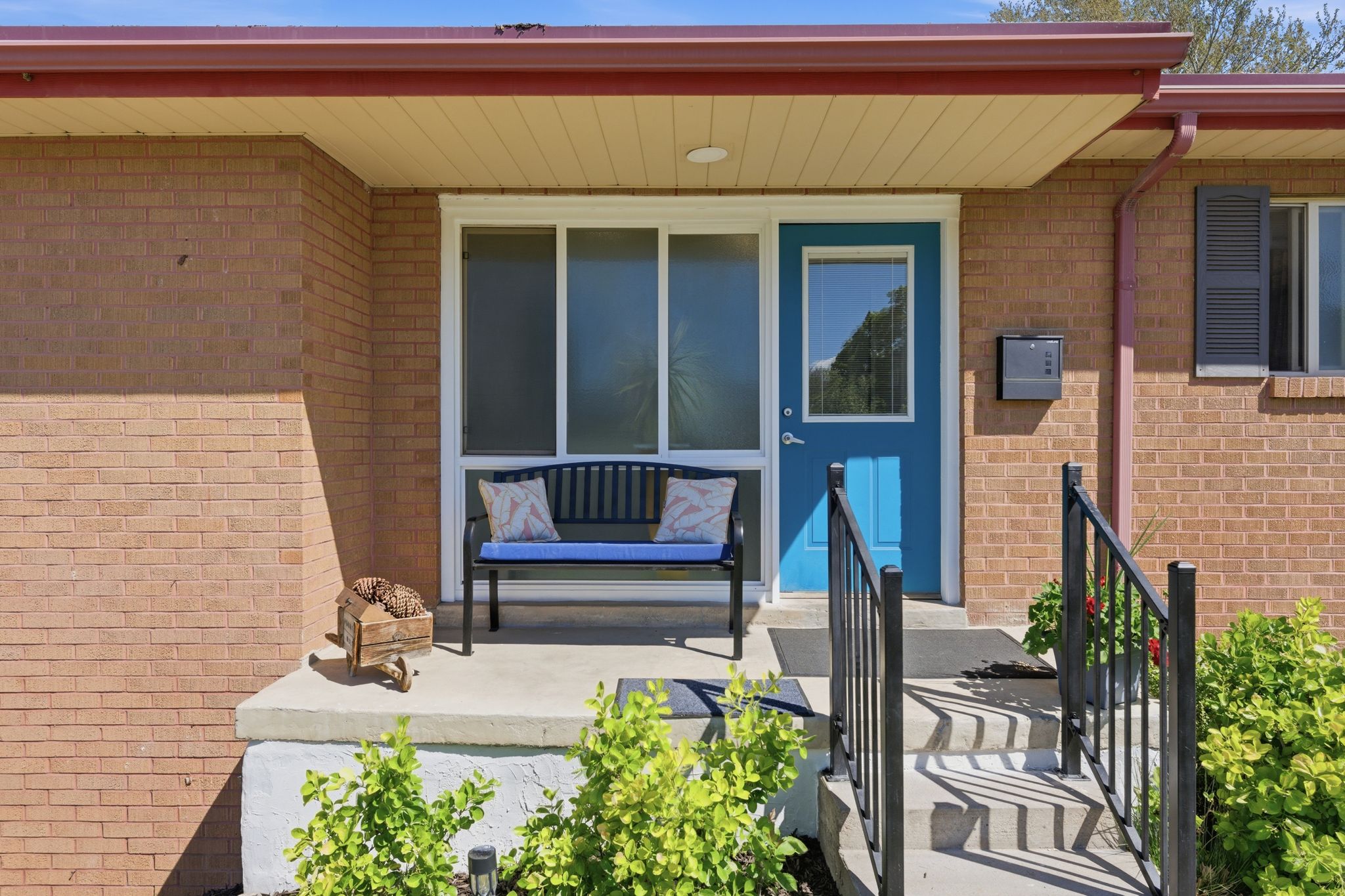 Entrance to property featuring brick siding and covered porch