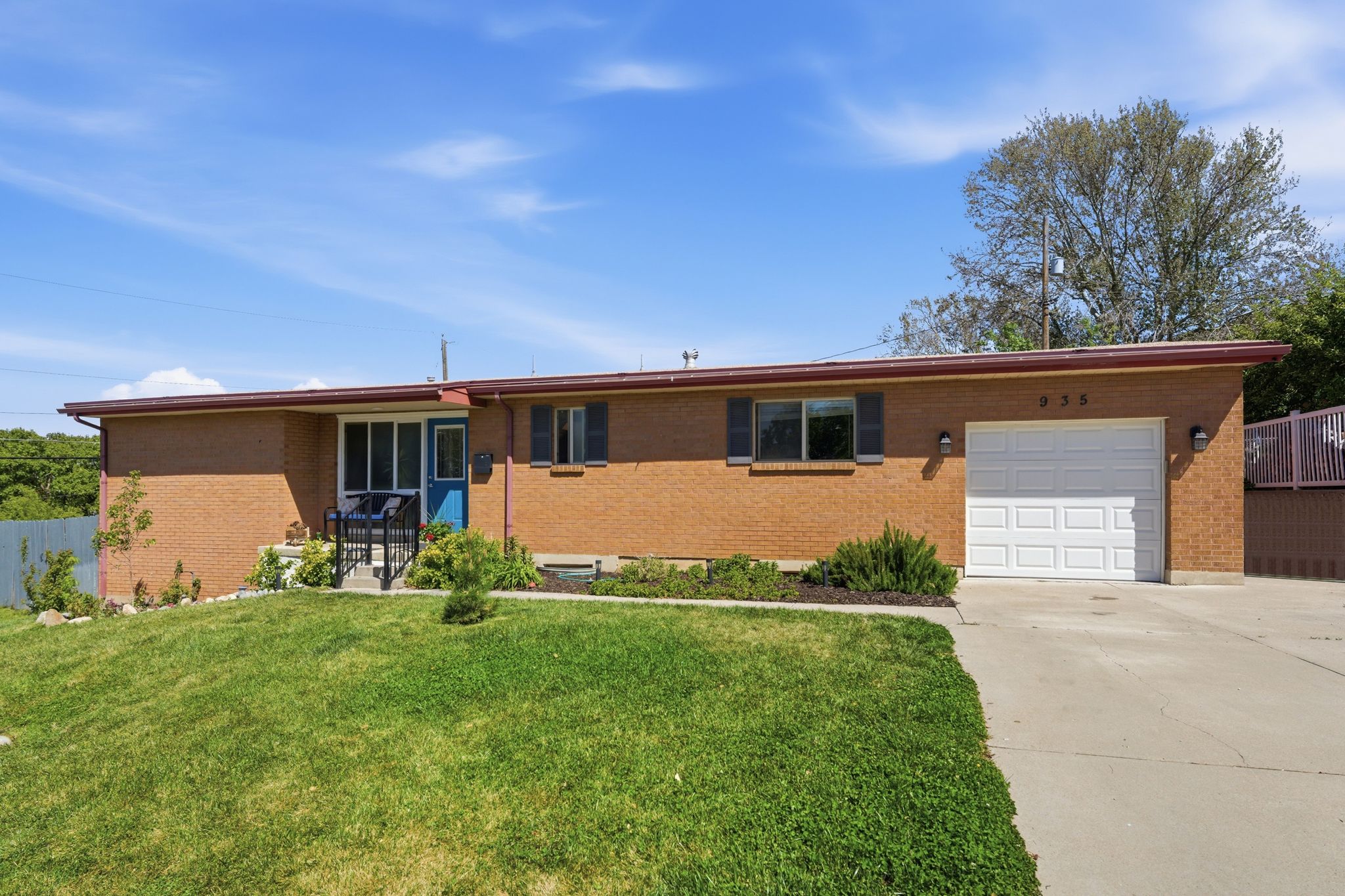 Ranch-style house featuring an attached garage, driveway, and brick siding