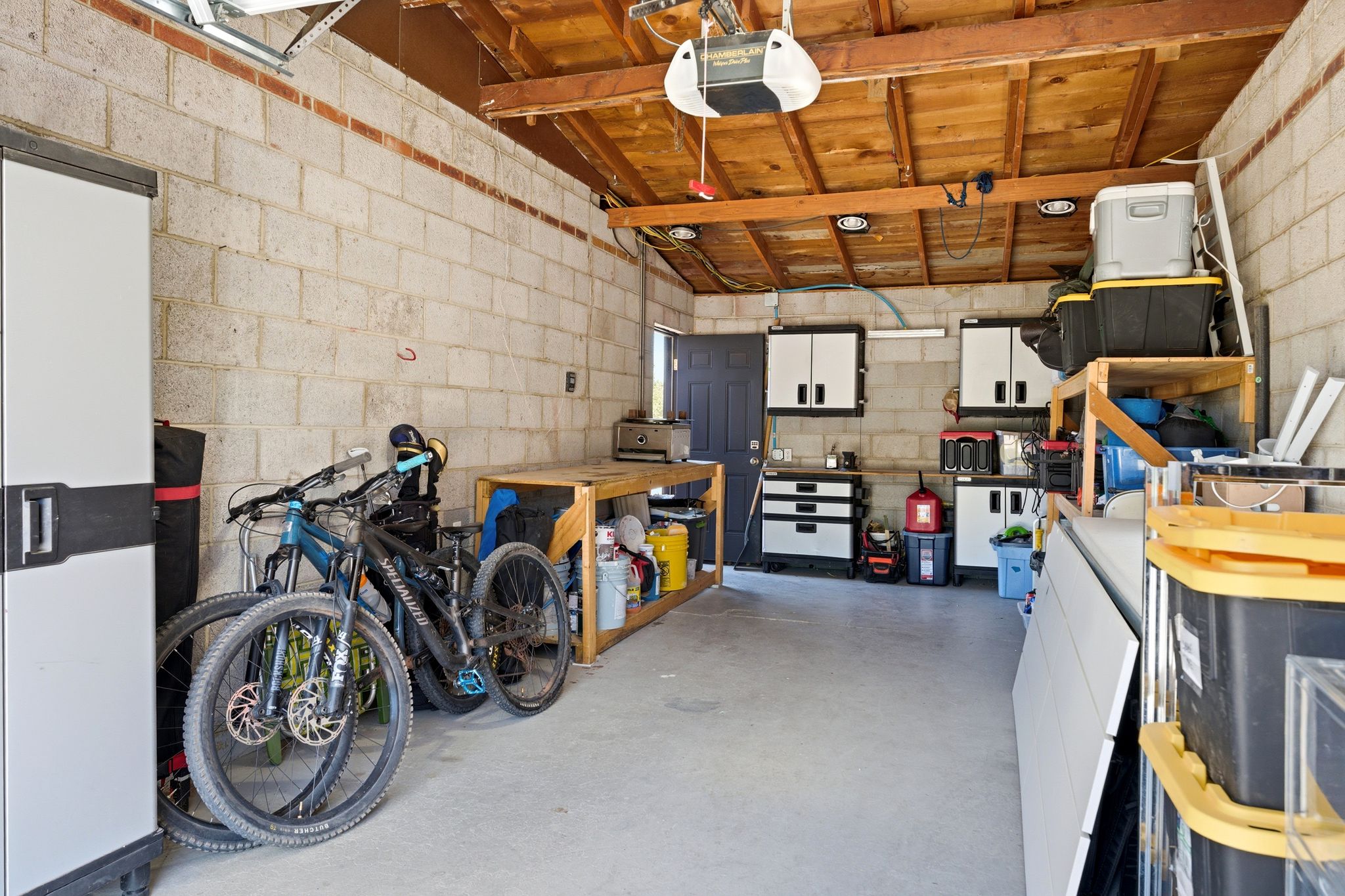 Garage with concrete block wall and a garage door opener